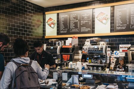 London, UK - September 07, 2019: Barista serving customers inside Pret a Manger, a popular international sandwich shop chain that is based in UK and has approximately 500 shops in nine countries.のeditorial素材