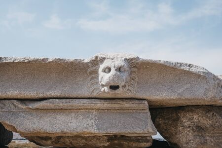 Architectural head details on the ruins on Sacred Way in island of Delos, an archaeological site in Greece near Mykonos in the Aegean Sea Cyclades archipelago.の写真素材