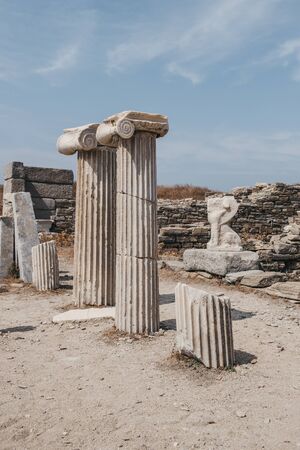 Columns and ruins on the Sacred Way on the island of Delos, Greece, an archaeological site near Mykonos in the Aegean Sea. Selective focus.の写真素材