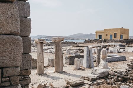 Columns and ruins on the Sacred Way on the island of Delos, Greece, an archaeological site near Mykonos in the Aegean Sea. Selective focus.の写真素材