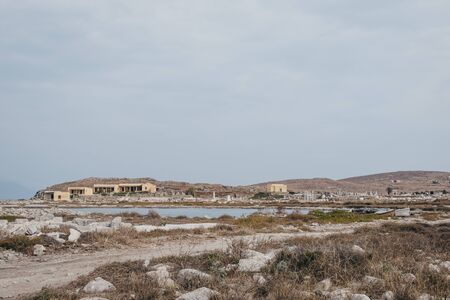 Ruins by the Sacred Lake on the island of Delos, Greece, an archaeological site near Mykonos in the Aegean Sea Cyclades archipelago.の写真素材