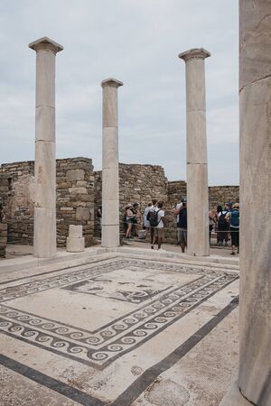Delos, Greece - September 20, 2019: People walking around House of Dionysos ruins on the island of Delos, archaeological site near Mykonos in the Aegean Sea Cyclades archipelago.のeditorial素材