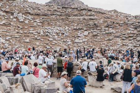 Delos, Greece - September 20, 2019: Large number of tourists watching performance at the ancient theatre on the Greek island of Delos, an archaeological site in the Aegean Sea. Selective focus.のeditorial素材