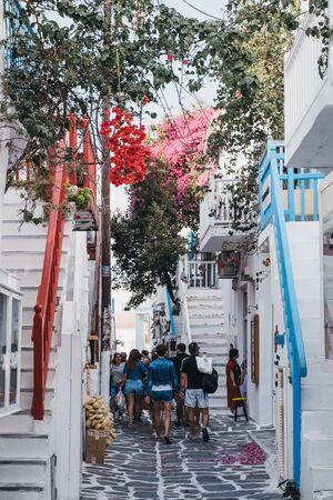 Mykonos Town,Greece - September 20, 2019: Colourful railings on a narrow street in Hora (also known as Mykonos Town), the islands well-preserved port and capital, people on background, selective focusのeditorial素材