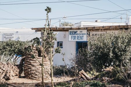 Mykonos Town, Greece - September 23, 2019: Rooms and apartments for rent sign on a house in Hora...