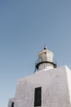 Low angle view of Armenistis Lighthouse in Mykonos, Greece, against blue sky, copy space.の写真素材