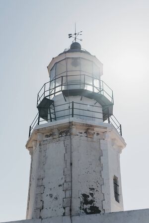 Close up low angle view of the exterior of Armenistis Lighthouse in Mykonos, Greece, against blue sky.の写真素材