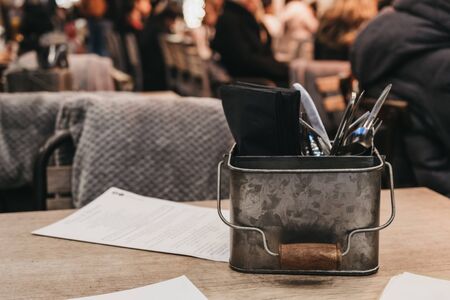 Cutlery caddy on an outdoor table of a restaurant, selective focus.の写真素材