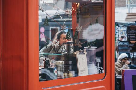 London, UK - December 29, 2019 Food stall with Christmas decorations in Elys Yard, a popular...