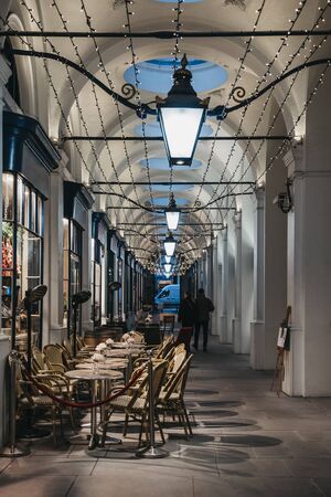London, UK - November 24, 2019: Outdoor tables of a restaurant in Royal Opera Arcade, London. It is the oldest arcade in London and has survived fire and The Blitzのeditorial素材