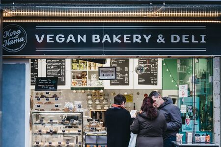 London, UK - November 26, 2019: People ordering food from a vegan deli inside Camden Market, London. Started with 16 stalls in 1974, Camden Market is one of the busiest retail destinations in London.のeditorial素材