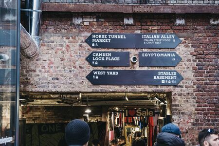 London, UK - November 26, 2019: Directional signs in Camden Market, a popular tourist attraction and the busiest retail spot in London, UK. Selective focus.のeditorial素材