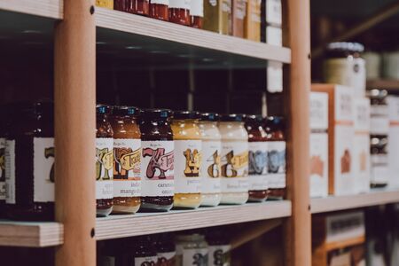 London, UK - November 26, 2019: Row of chutney jars on sale inside the Camden Grocer, a luxury deli and cafe in Camdens Stables Market, London, UK. Selective focus.のeditorial素材