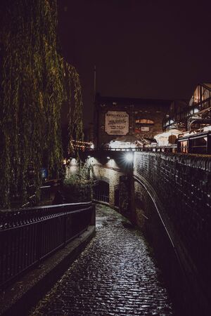 London, UK - November 26, 2019: Illuminated walkway along Regents Canal near Camden Market, London,...
