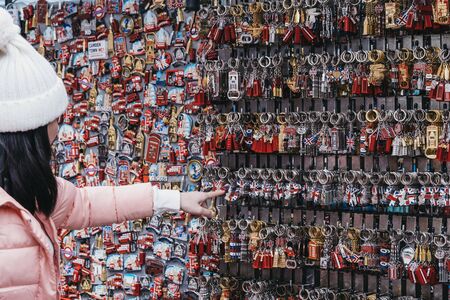 London, UK - November 26, 2019:  Woman choosing souvenirs at a stall inside Camden Market, a popular tourist attraction and the busiest retail spot in London, UK.のeditorial素材