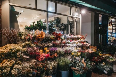 London, UK - November 26, 2019: Flowers on display in front of a florist shop in Primrose Hill, an upscale area of North London that got its name from the famous Primrose Hill, at night.のeditorial素材