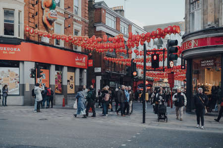 London, UK - March 06, 2020: People walking on a street in Chinatown, London. Chinatown is home to a large East Asian community and is famous for its eateries and events.のeditorial素材