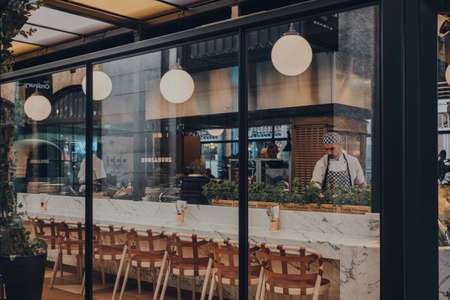 London UK - March 06, 2020: View through the window of staff cooking inside the restaurant in Covent Garden Market, one of the most popular tourist sites in London, UK.のeditorial素材
