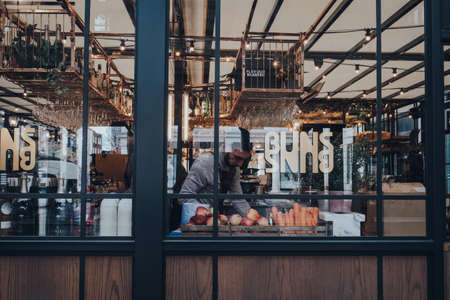 London UK - March 06, 2020: View through the window of staff cooking inside the restaurant in Covent Garden Market, one of the most popular tourist sites in London, UK.のeditorial素材