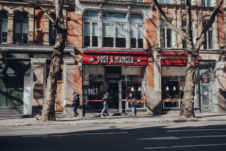London, UK - March 06, 2020: People walking past Pret A Manger, a popular international sandwich shop chain that is based in UK and has approximately 500 shops in nine countries, in Central London.のeditorial素材