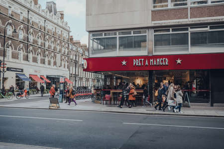 London, UK - March 06, 2020: People walk past Pret A Manger, a popular international sandwich shop chain that is based in UK and has approximately 500 shops in nine countries, in Central London.のeditorial素材