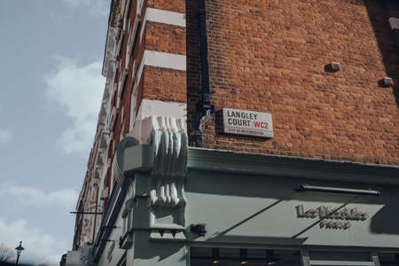London, UK - March 6, 2020: Street name sign on a building in Langley Court in Covent Garden, an area of London famous for its bars, restaurants and cafes, on a sunny spring day.のeditorial素材