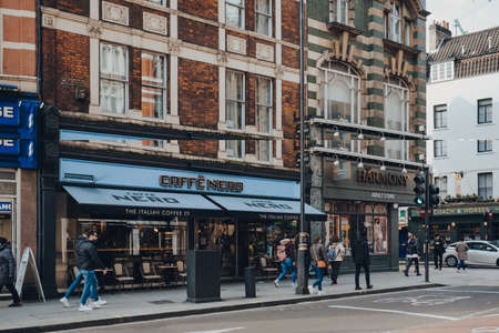 London, UK - March 06, 2020: Facade of Cafe Nero, a British European style coffee house brand headquartered in London, England, people walking by, motion blur, selective focus.のeditorial素材