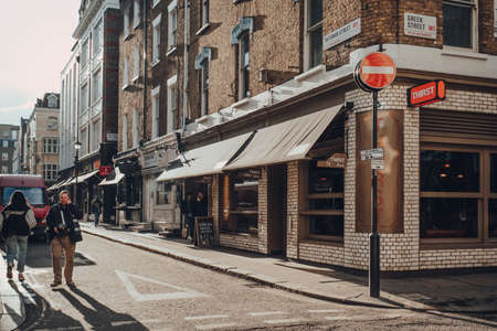 London, UK - March 06, 2020: Thirst restaurant on a street in Soho, an area of London famous for LGBTQ+ bars, restaurants and clubs, people walking past.のeditorial素材
