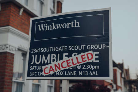 London, UK - April 12, 2020: Cancelled jumble sale sign by Winkworth outside a house in Palmers Green, London. Winkworth is one of the longest established estate agents in London & the UK.のeditorial素材