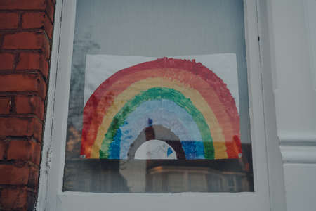 London, UK - April 12, 2020: Handmade rainbow sign displayed in a window of a house in London as people support each other during lockdown because of Coronavirus.のeditorial素材