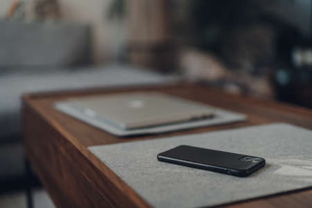 London,UK - May 5,2020: iPhone 11 Pro Max by Apple on a table at home, laptop on background, selective focus. People around the world have been working from home because of lockdown due to Coronavirusのeditorial素材