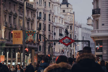 Madrid, Spain - January 26, 2020: Metro sign on Gran Via station, located underneath Gran Via and Red de San Luis Plaza in the Centro district of Madrid, Spain. People walk past, selective focus.のeditorial素材