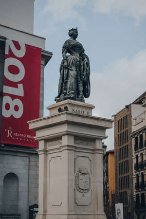 Madrid, Spain - January 26, 2020: Statue of Isabel II in front of Royal Theatre (Teatro Real, also known as El Real), a major opera house located in Madrid, against the sky.のeditorial素材