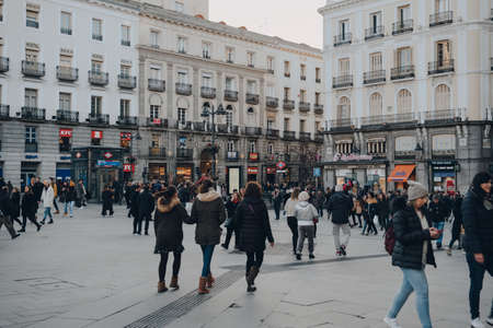 Madrid, Spain - January 26, 2020: Many people walking on Puerta del Sol, a public square in Madrid and one of the best known and busiest places in the city.のeditorial素材