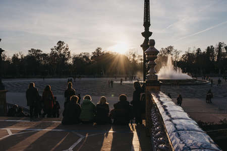 Seville, Spain - January 17, 2020: People enjoying sunset at Plaza de EspaÃ±a, a plaza in the Parque de MarÃ­a Luisa, in Seville, Spain, built in 1928 for the Ibero-American Exposition of 1929.のeditorial素材
