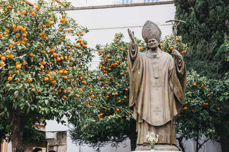 Seville, Spain - January 17, 2020: Close up of a bronze statue of Pope John Paul II in The Plaza de Virgen de los Reyes, is historic square in Seville, Andalusia, Spain.のeditorial素材
