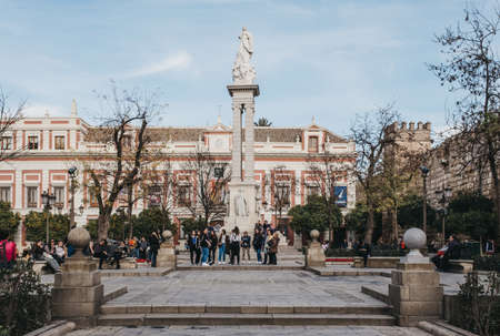 Seville, Spain - January 17, 2020: Monument on Plaza del Triunfo, small plaza and popular meeting spot in Seville known for its adjacent historic buildings, people walking around.のeditorial素材