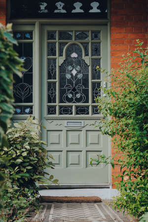 London, UK - May 26, 2020:Traditional stained glass front door of an Edwardian house in London,...