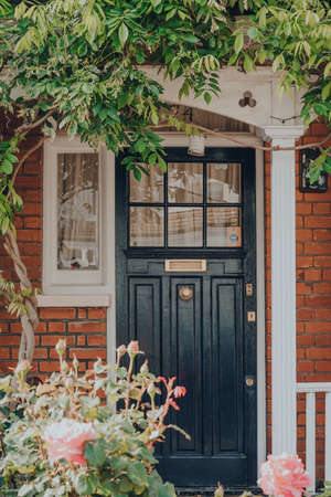 London, UK - May 26, 2020: Black front door of a traditional Edwardian house in London, selective focus. Edwardian houses promote simple design and an appreciation for the handmade.のeditorial素材