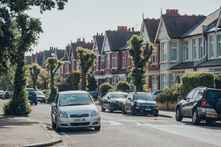 London, UK - May 26, 2020: Cars parked in front of houses on both sides of a street in Palmers Green, a suburban area in the London Borough of Enfield in North London, UK.のeditorial素材