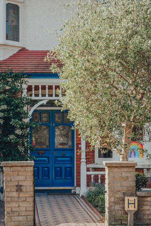 London, UK - May 30, 2020: Blue stained glass front door of an Edwardian house in London, selective focus. Edwardian houses promote simple design and an appreciation for the handmade.のeditorial素材