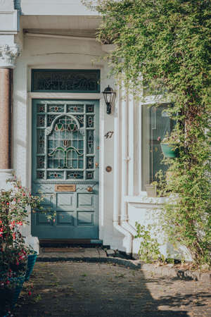 London, UK - May 26, 2020: Pastel stained glass front door of Edwardian house in London, sunlight...
