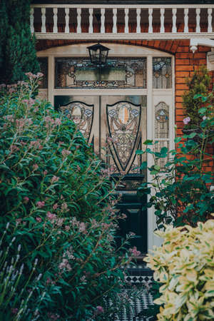 London, UK - May 26, 2020: Black stained glass front door of an Edwardian house in London, selective focus. Edwardian style promotes simple design and an appreciation for the handmade.のeditorial素材
