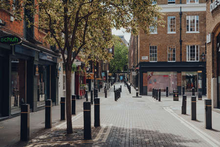 London, UK - June 13, 2020: Empty street and closed shops and cafes in Covent Garden, a typically busy area of London famous for its retails, restaurants and cafes, on a sunny summer day.のeditorial素材