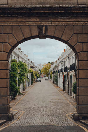 London, UK - June 20, 2020: View of Holland Park Mews through the sotne arch. Houses in mews are one of the most luxurious and desirable properties in West London.のeditorial素材