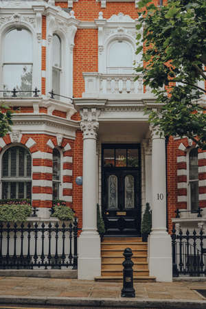 London, UK - June 20, 2020: Cars parked in front of white Victorian houses on a street in Holland park, an affluent area of West London favoured by celebrities.のeditorial素材