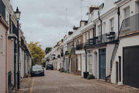 London, UK - June 20, 2020: Rows of townhouses with garages on Holland Park Mews. Houses in mews are one of the most luxurious and desirable in West London.のeditorial素材