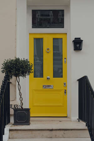 London, UK - June 20, 2020: Cars parked in front of white Victorian houses on a street in Holland park, an affluent area of West London favoured by celebrities.のeditorial素材