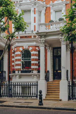 London, UK - June 20, 2020: Cars parked in front of white Victorian houses on a street in Holland park, an affluent area of West London favoured by celebrities.のeditorial素材