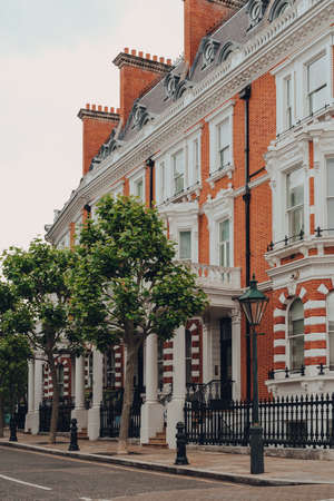 London, UK - June 20, 2020: Cars parked in front of white Victorian houses on a street in Holland park, an affluent area of West London favoured by celebrities.のeditorial素材